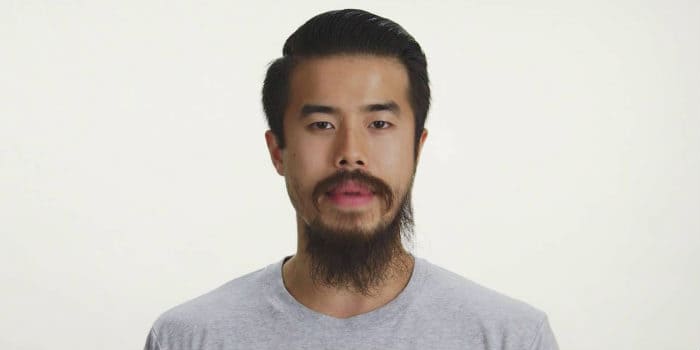 Asian male with grey shirt and thin balbo style beard