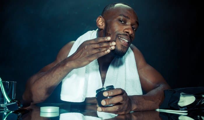 african american man using facial hair conditioner