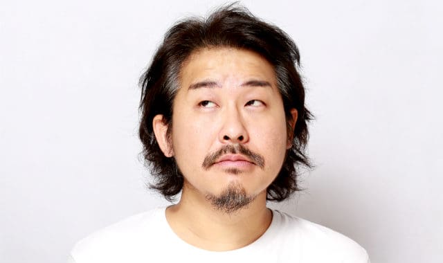 asian man with patchy mustache and facial hair on chin