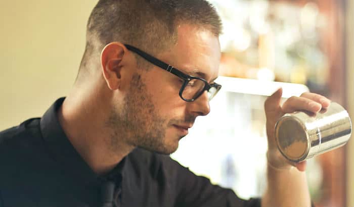 bartender with a prominent 5 o clock shadow stubble