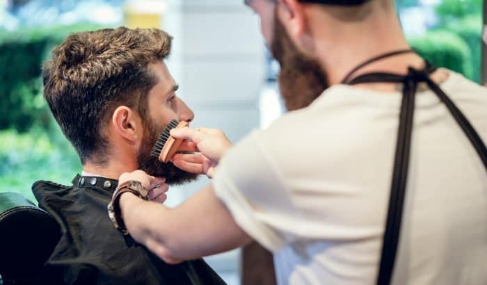 barber using a small beard brush