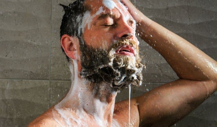 man washing his beard