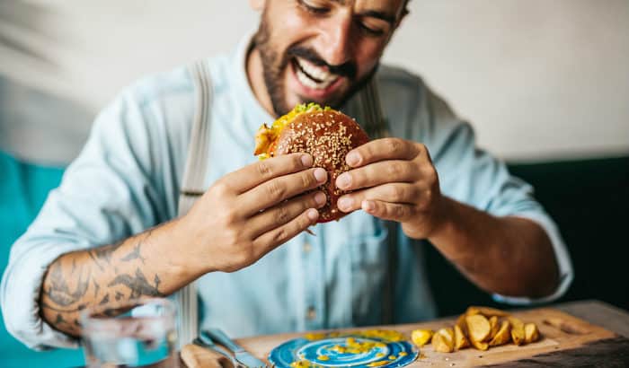 bearded man eating food