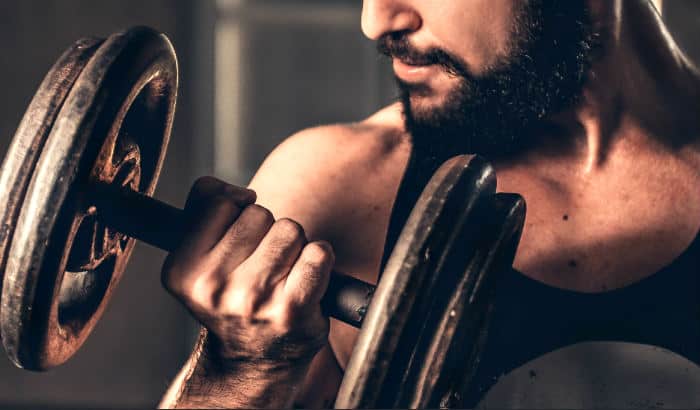 bearded man lifting weights