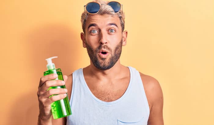 bearded man with aloe vera bottle