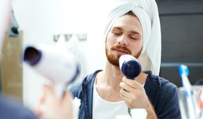 man straightening his beard