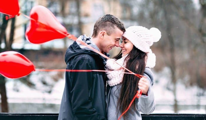 clean-shaven man and a woman with heart balloons