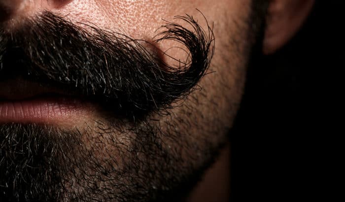 closeup of bold mustache and heavy stubble