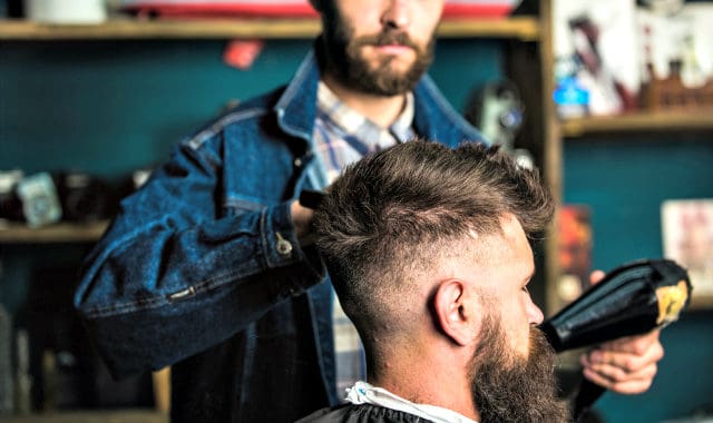 man blow drying beard