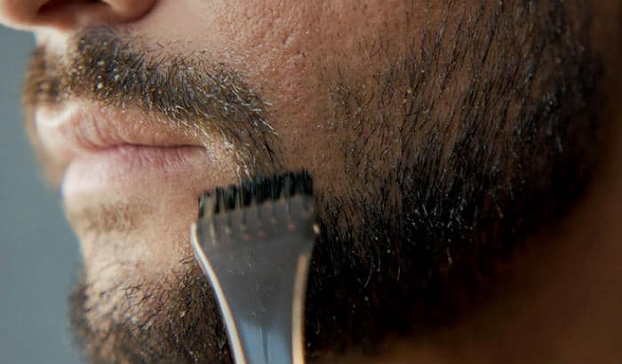 man brushing beard dye in