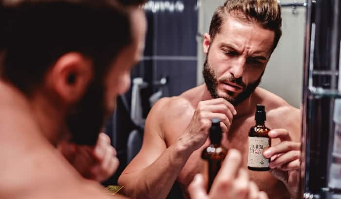 man choosing the right jojoba oil for his beard