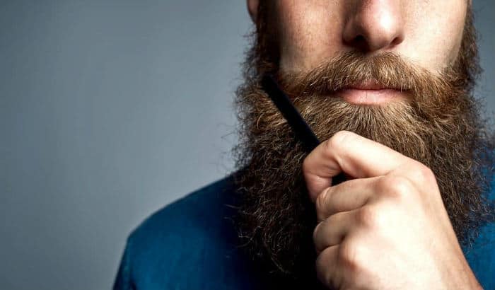 man combing a year long beard