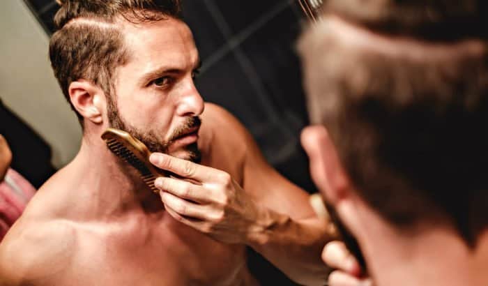 man combing his beard