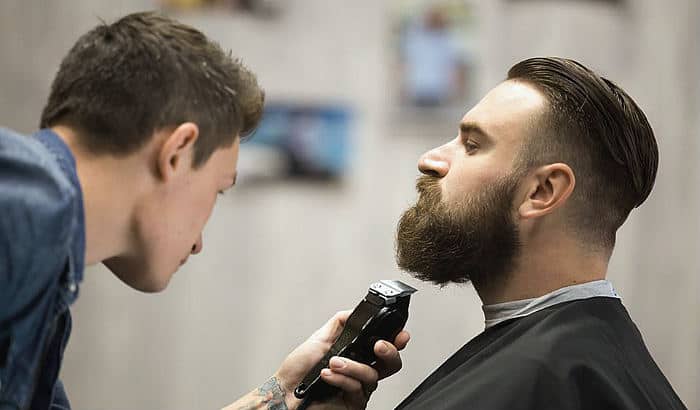 man getting a beard trim with low neckline