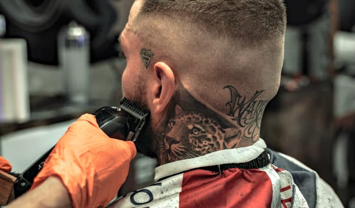 man getting his beard cowlick trimmed at barbershop