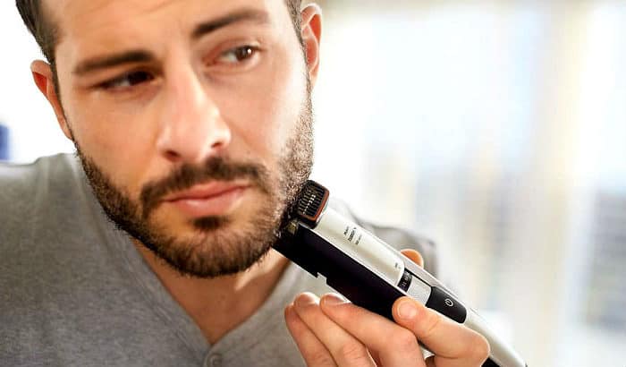 man maintaining a designer stubble with a trimmer