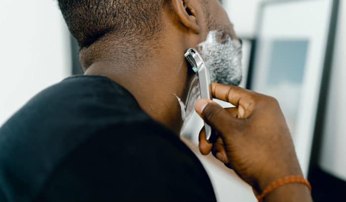 man shaving his neckline