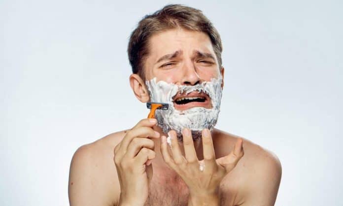 man shaving with razor bumps