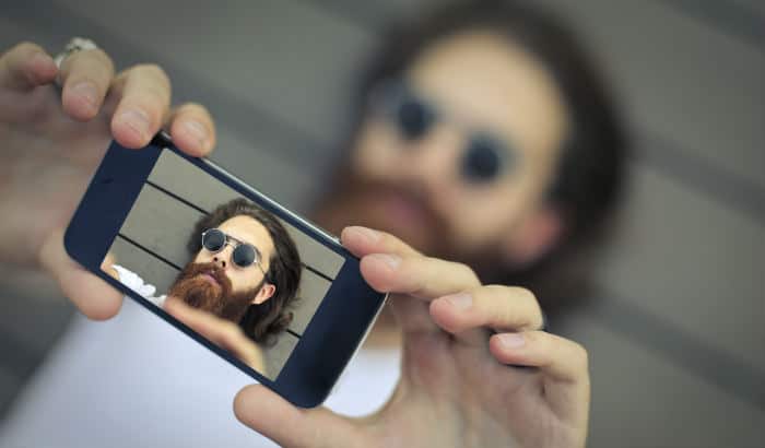 man taking picture of his beard