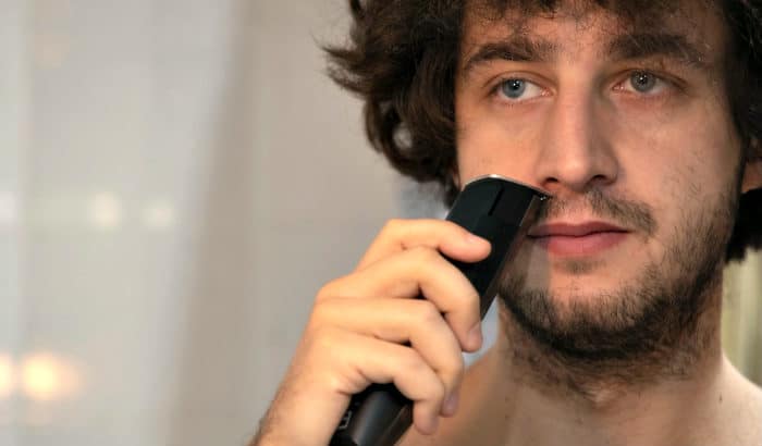 man trimming a short beard