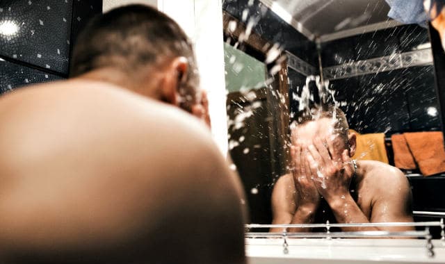 man washing his beard