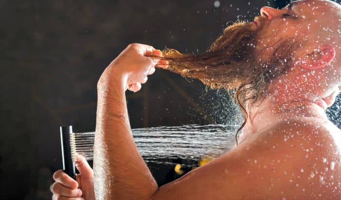 man washing his facial hair