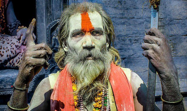 man with colored beard and skin paint