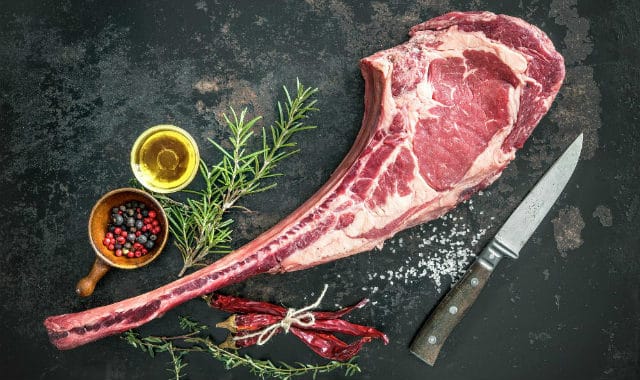 cut of steak with knife and spices