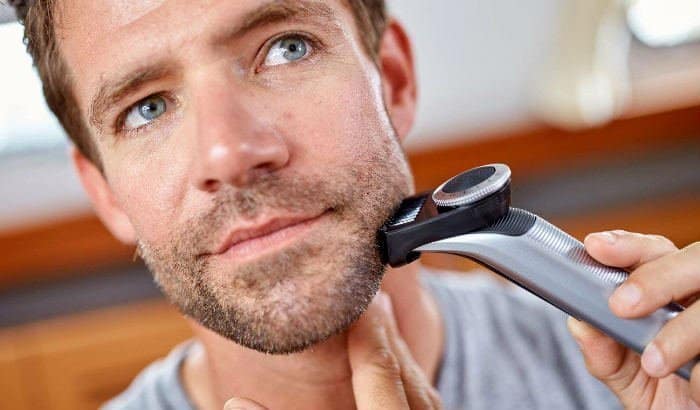 man trimming a stubble beard