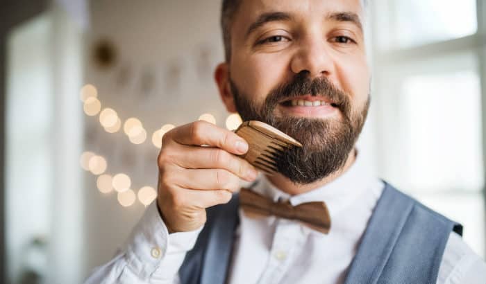 sophisticated man with a wooden beard comb