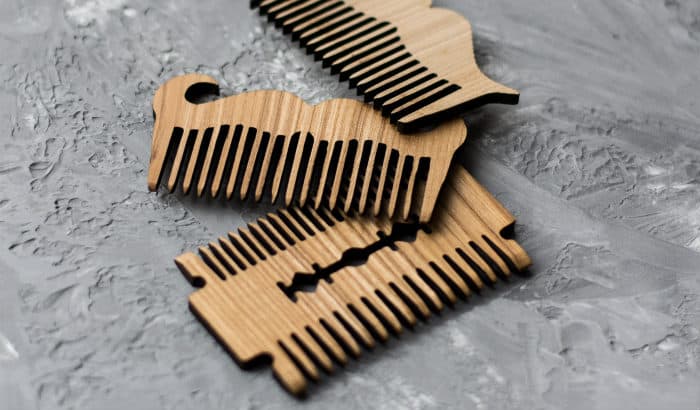 three wooden beard comb designs