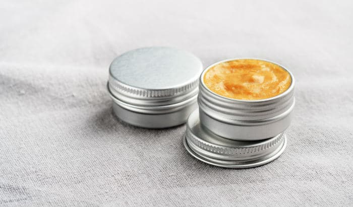 two tins of beard butter on a piece of cloth