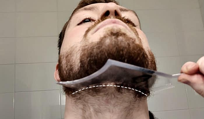 using a beard shaping tool on the neckline