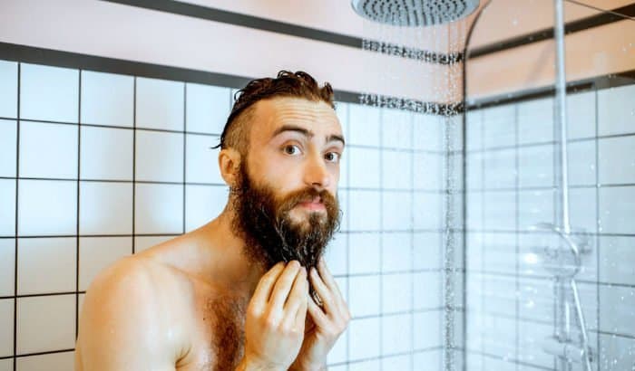 man washing his beard