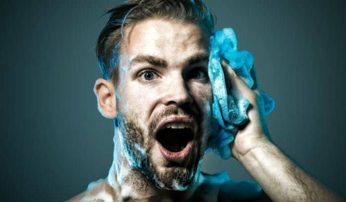 man washing his beard